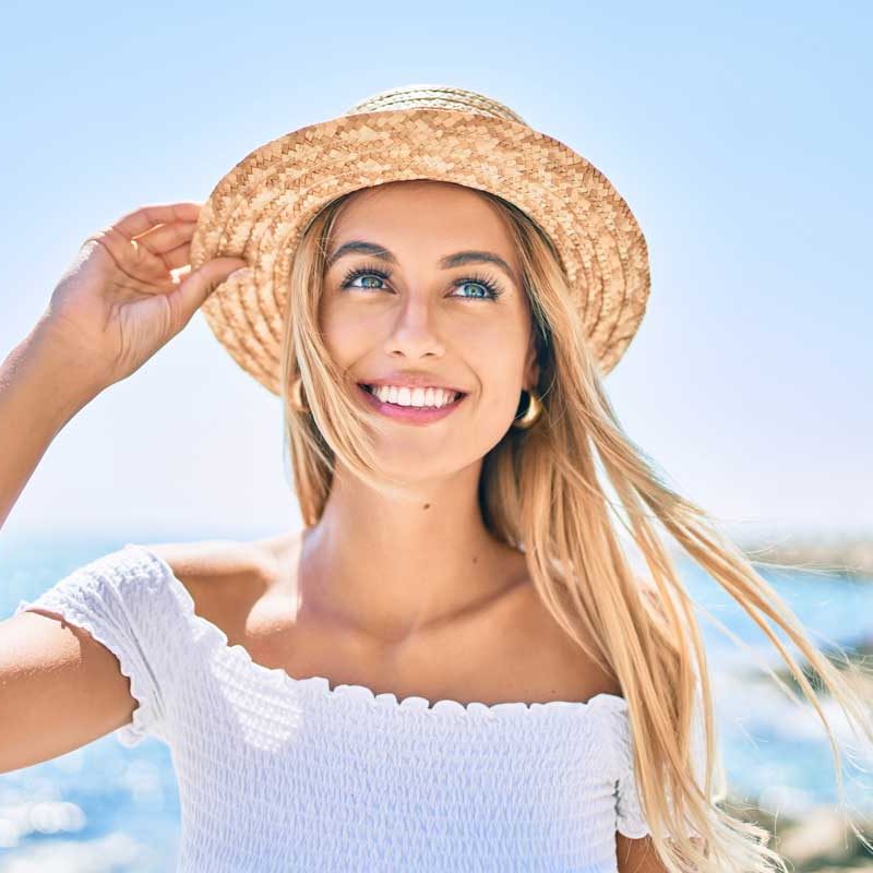 girl-with-beautiful-smile Young blonde tourist girl smiling happy looking to the side walking at the promenade.